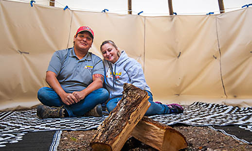Couple sits inside a tent at Kluskap Ridge in Cape Breton.