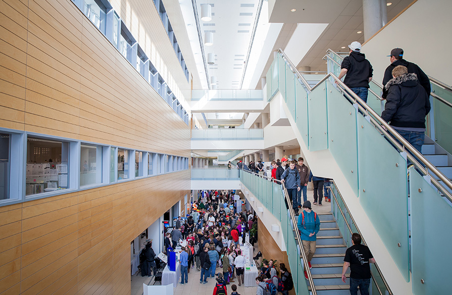 Ivany Campus's hallways and stairwells filled with students between classes.