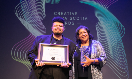 Protege winner Andre Fenton and Portia White Prize Winner Juanita Peters on stage together holding their awards.