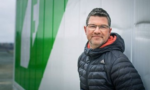 Phil Hatcher standing outside one of his 40-foot shipping containers on the Dartmouth waterfront that he uses for his hydroponic farming business.