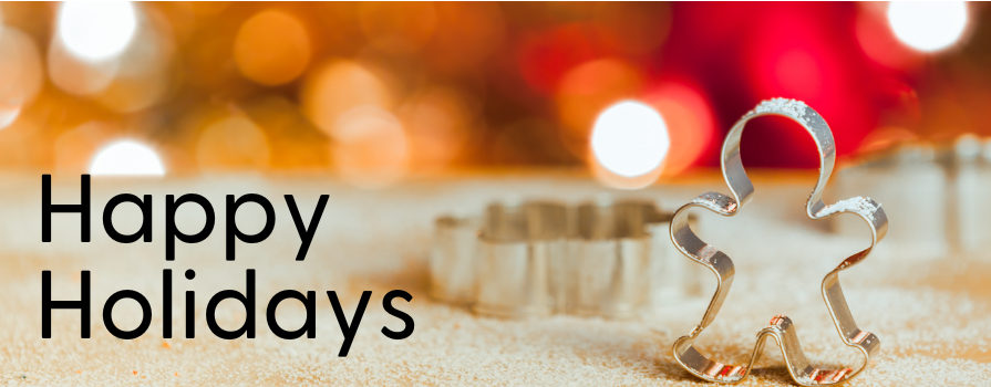 A gingerbread cookie cutting standing on a sugar covered counter with blurry lights in the background, and text that reads Happy Holidays.