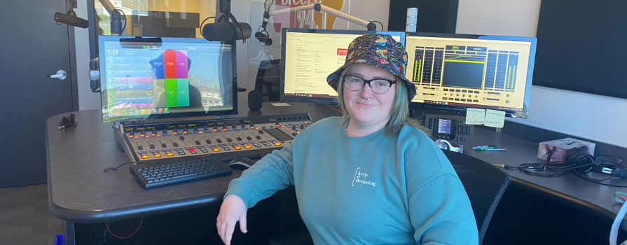 Emma Freckelton sitting in 94.1 The Breeze's radio studio.