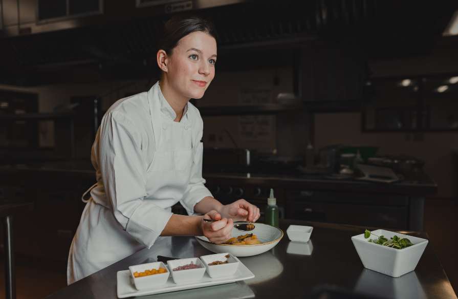 Olivia Sewell preparing a dish in the NSCC Akerley Campus kitchen.