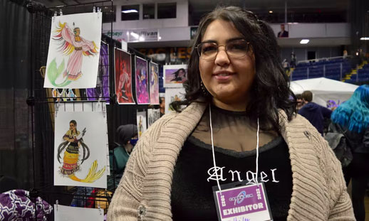 Hailee McDonald stands beside her booth at CaperCon 2022 in Sydney.