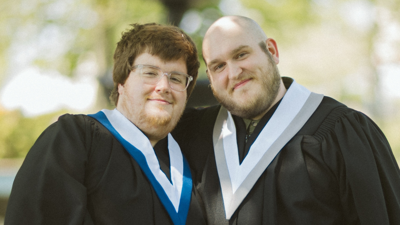 2024-25 NSCC Foundation and Alumni Relations Annual Report cover photo of NSCC alum couple Zach and Dustin in their convocation gowns.
