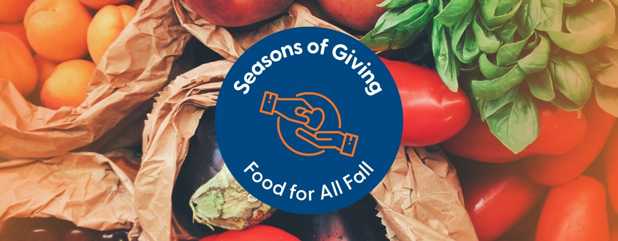 Photo of vegetables with blue circle in the centre saying "Seasons of Giving Food for All Fall" in white text with orange symbol of hand giving a heart to another hand.