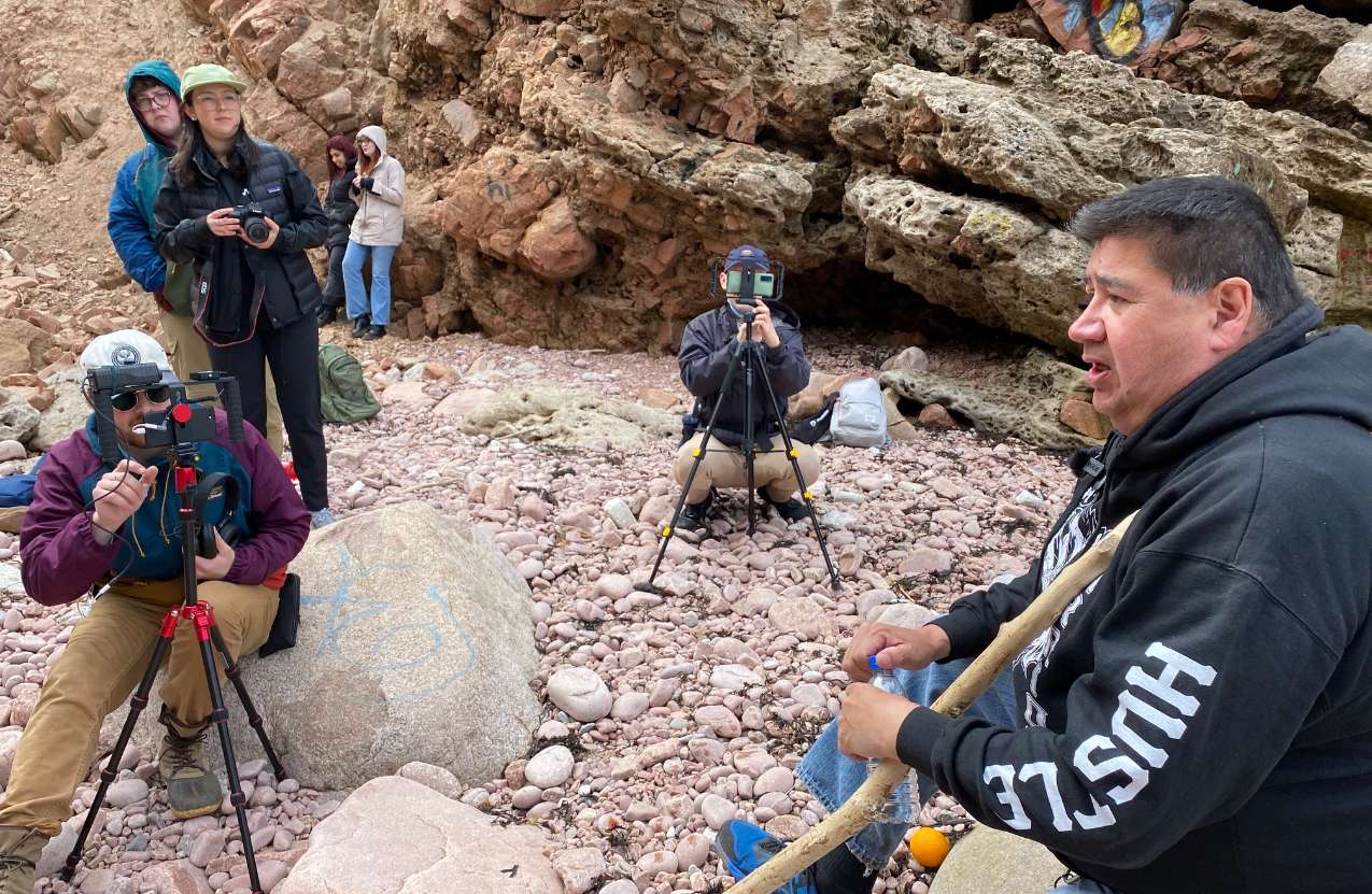 Photo of Clifford Paul of the Unama’ki Institute of Natural Resources being interviewed at Kluscap’s Cave. Photo credit: Erin Moore