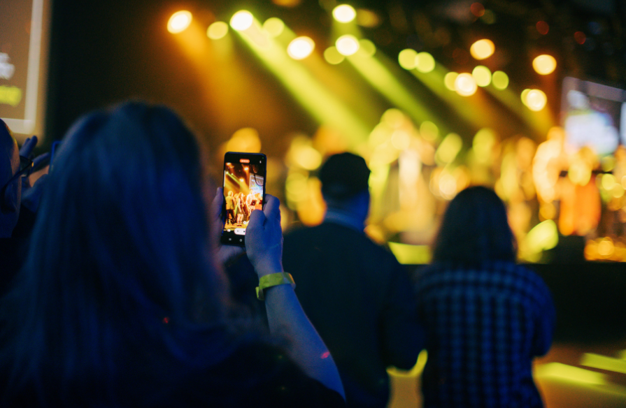 Photo of attendee recording musical performance at Spark Creativity.