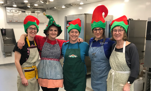 Group photo from left to right of Phil, Olivia, Nicole, Michelle, and Bern Byers at NSCC's Kingstec Campus making cheesecakes for cheesecake raffle winners.