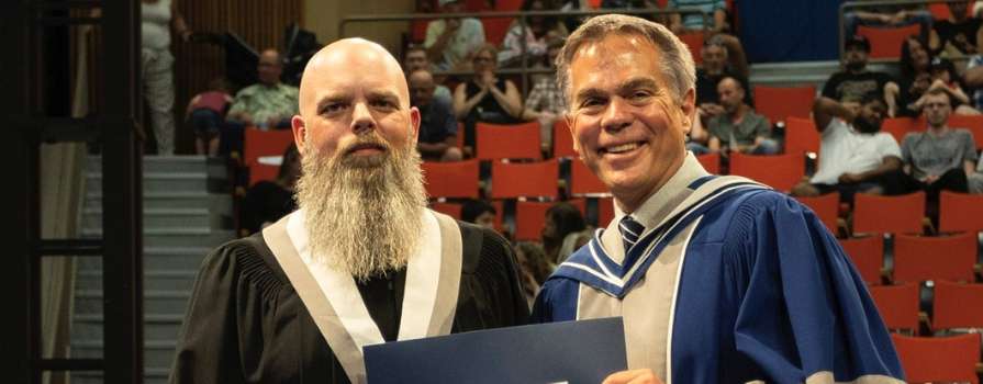 Photo of Smart WIL Award recipient, Wesley Amirault, at graduation with NSCC President, Don Bureaux.