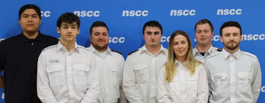 Photo of 2024 Marine Skills Competition winning team, Knots and Bolts. From left to right, John P., Caleb V.; Sean M., Pieter B., Natasha C., John H., Ryan M.