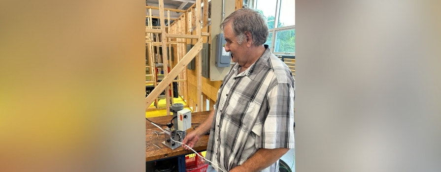 Photo of Program Assistant, Phil Seaboyer, using the wire stripper purchased to increase the value of recyclable copper wire.