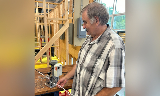 Photo of Program Assistant, Phil Seaboyer, using the wire stripper purchased to increase the value of recyclable copper wire.