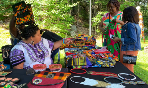 Digby entrepreneur Barbara Roberts chats with a customer visiting her booth, AfroNova, during the Takin' BLK Market at the Black Loyalist Heritage Centre during the Journey Back to Birchtown.