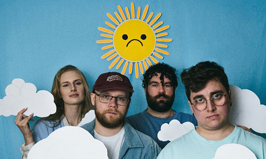 Four bandmates, 3 men and 1 women, pose in front of a blue sky background, with a frowning yellow sun above their heads while holding paper clouds in their hands.