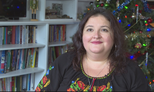  Olesya Shyvikova sitting in her living room during the holiday season. 