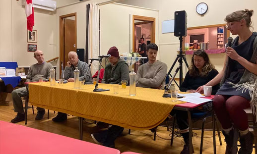 Numerous people are shown sitting at a "head table" - From left to right, they are: Jeff McMahon, Kevin Graham, Ken Byrka, James Twaddell and Sarah McDonald