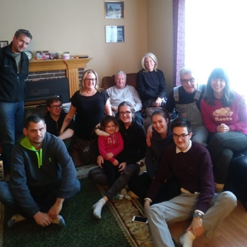 Photo of the Marshall family by a fireplace.