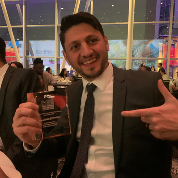 Mohammad holding his award at the Most Inspiring Immigrants in Atlantic Canada gala.