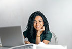 Photo of student on laptop smiling