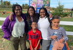 A Black family of five people at Noggins Farms in the valley.