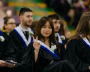 Photo of graduate making a peace sign with their hand at convocation