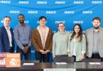 Don Bureaux and leaders from NSCC Student Associations in front a an NSCC backdrop about to sign the Sustainable Development Goals Accord.