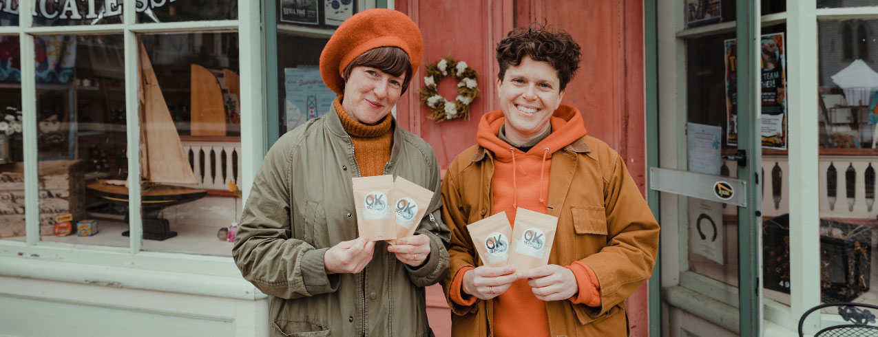 Kim, Business Administration student, and her partner Onya are holding a few packages of their sea salt outside a local store in LaHave, Nova Scotia.