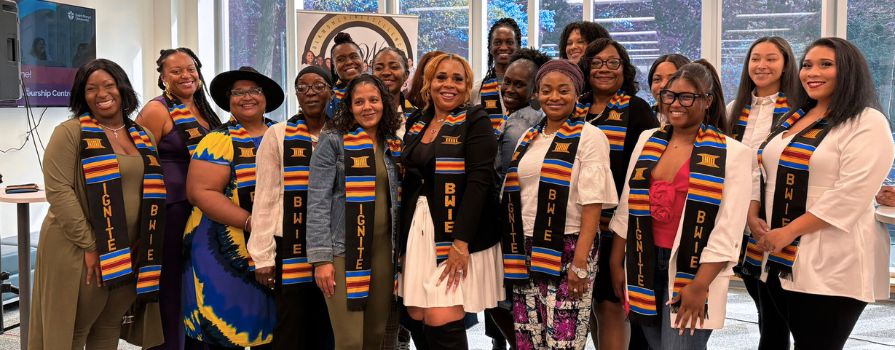 A group photo of women who completed a program through Blck Women in Excellence with Tia Upshaw, the Founder and CEO.