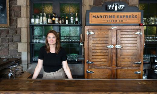 Genevieve Allen-Hearn behind the bar at Maritime Express Cider Company, a business that she co-founded.