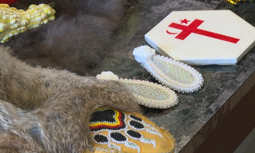 photo of beadwork, including earrings and moccasins.