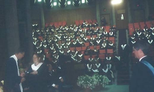 Sherri on stage at her convocation receiving her diploma.