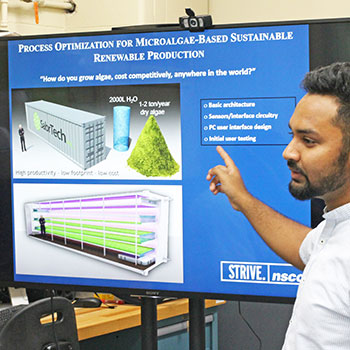 Research associate, Khan Sakib, presenting data on process optimization for microalgae production.