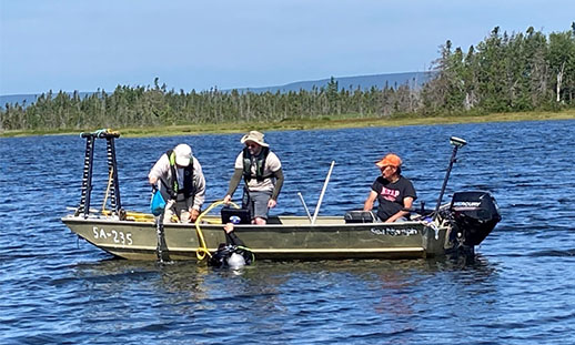 Researchers in a boat with ground trutting equipment in Bra