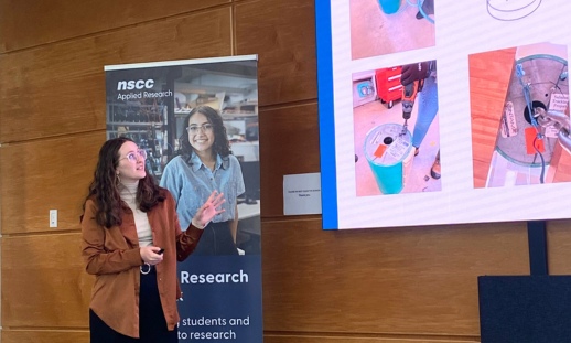 A young woman presenting a slide with a prototype design.