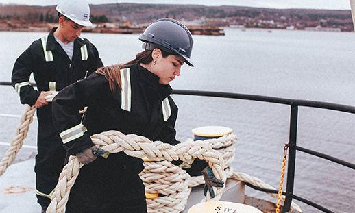 Bridge watch rating students standing on the deck of a ship