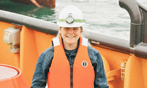 headshot of Kelsie Maclean on deck of tug boat