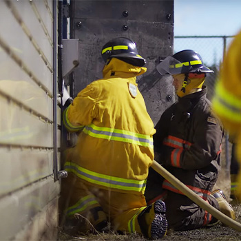 Bridge Watch Rating cadets learning to extinguish a fire.