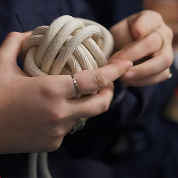 Close up shot of hands tying a large knot