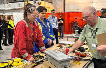 Marine students speaking with a judge during the Marine Skills Competition