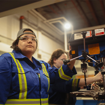 Michaela Julian operating a piece of machinery