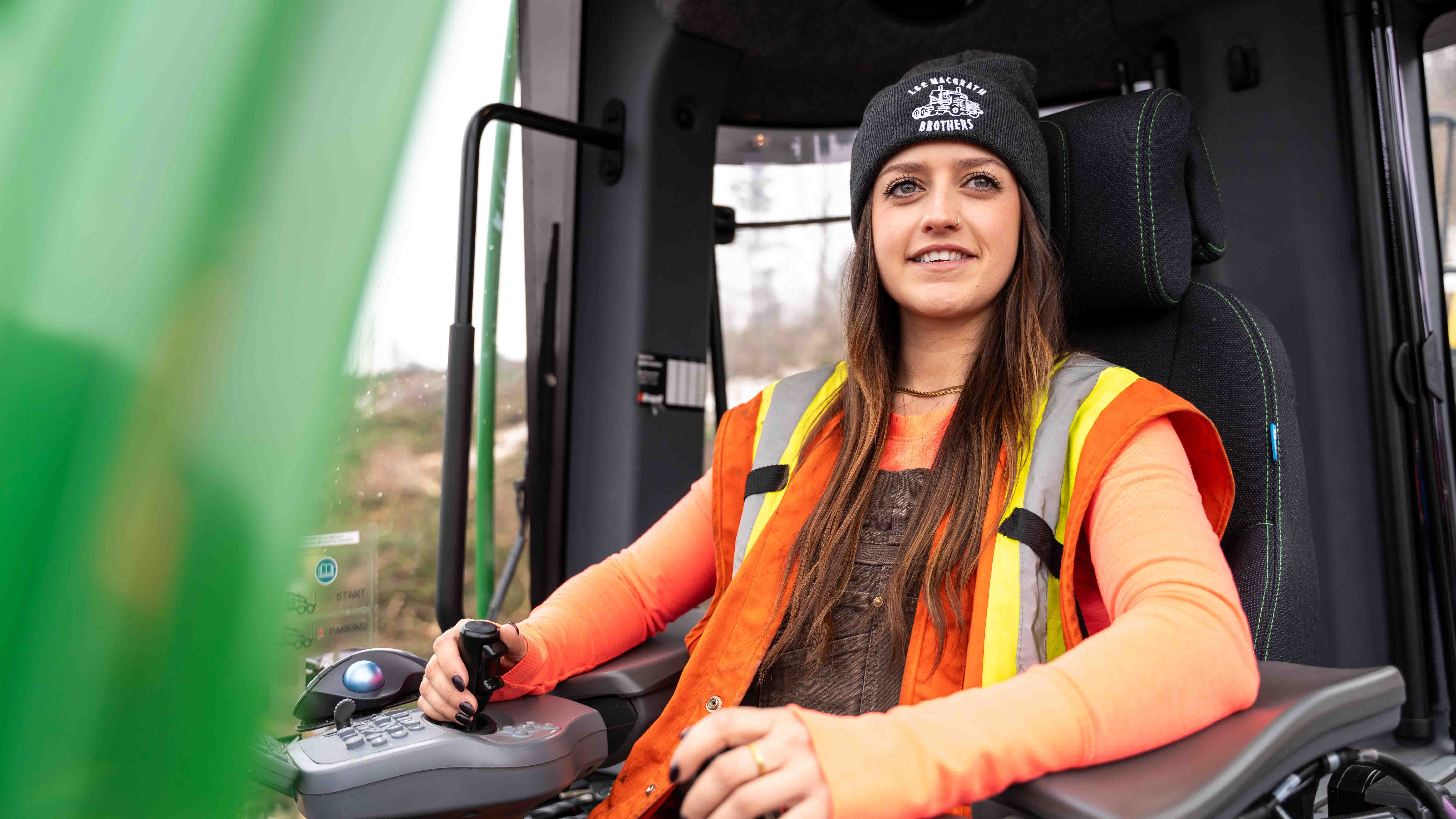 A female forest machine operator using a machine at work