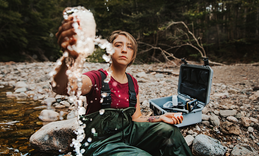 Kieran Wasuek Johnson tests water in a river.