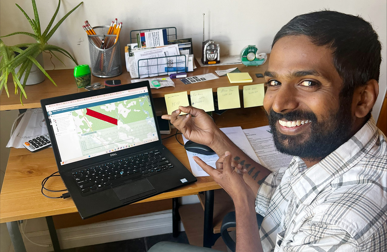 a student showing a forest map on a computer