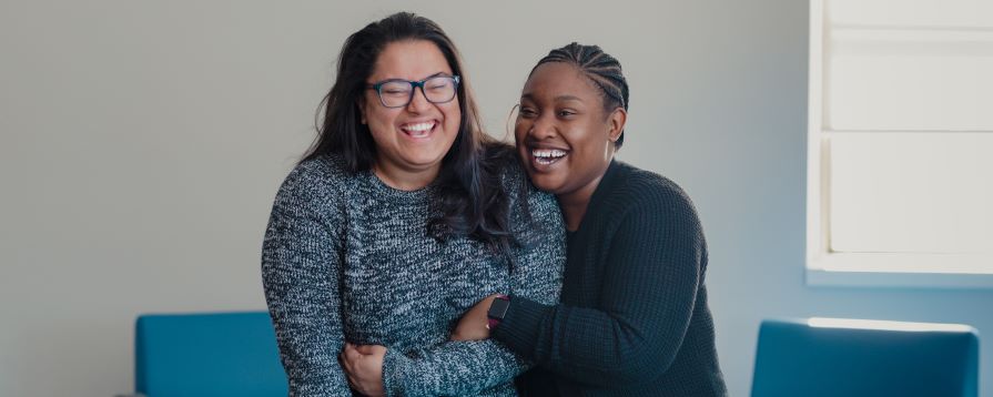 Photo of two nscc students hugging and smiling