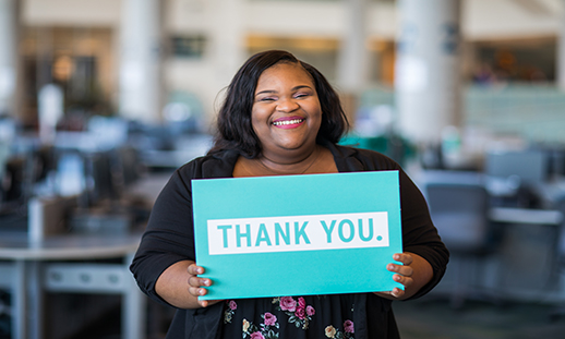 Photo of student holding a thank you sign.