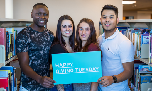 Photo of NSCC students holding blue sign saying, "Happy Giving Tuesday!"