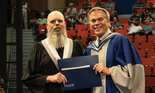 Photo of Smart WIL Award recipient, Wesley Amirault, at graduation with NSCC President, Don Bureaux.