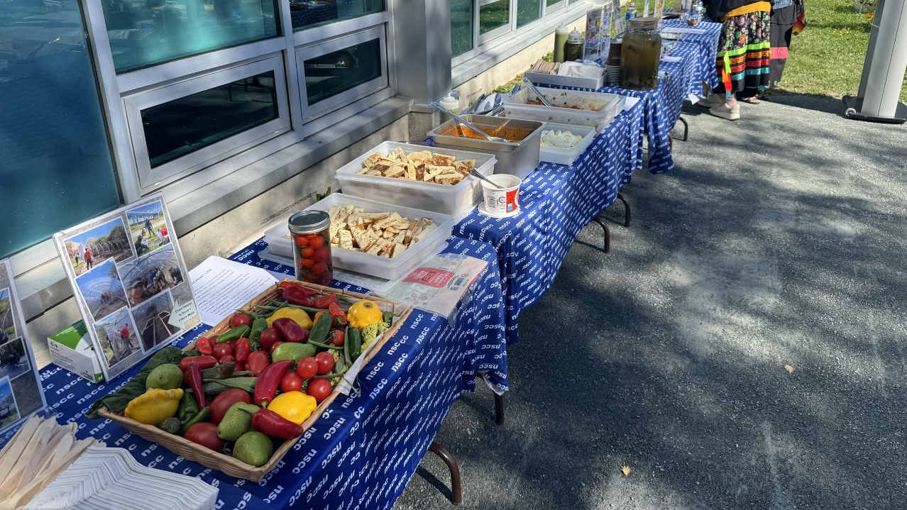 Produce and food on table after Iga'taqan's first harvest for the garden's opening ceremony.