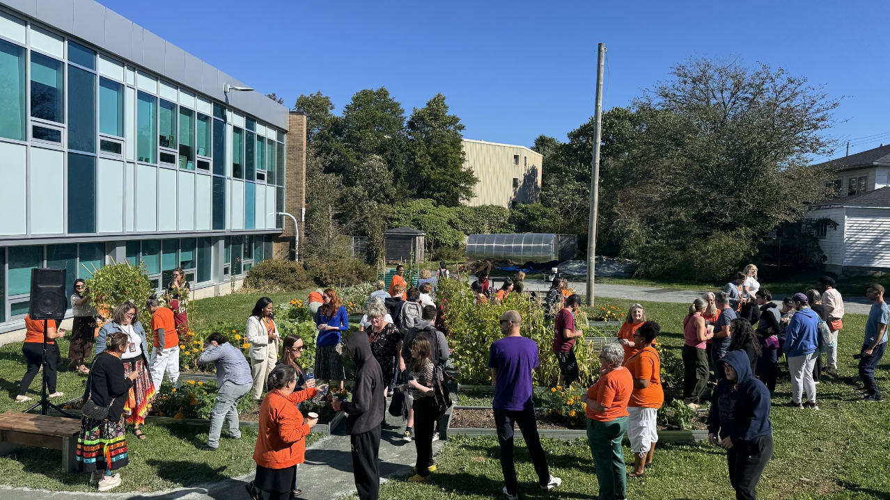 Iga'taqan Opening Ceremony attendees socializing in the garden.